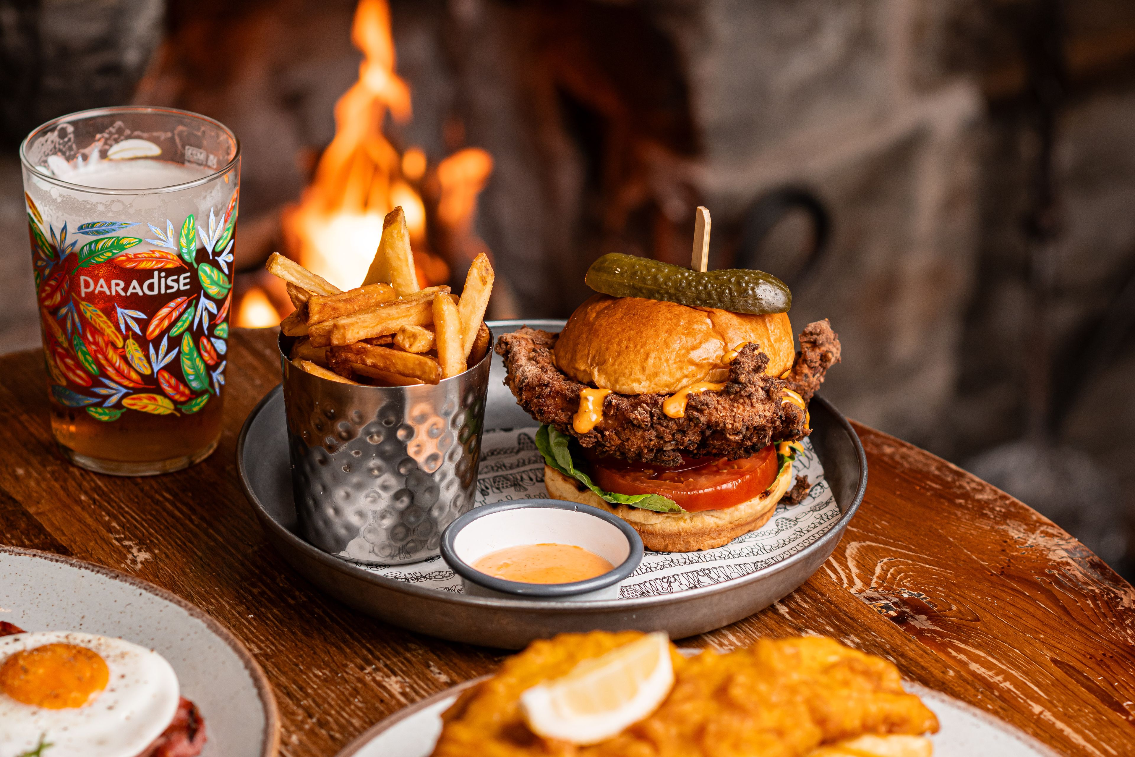 chicken burger and pint of thwaites ale by the fire